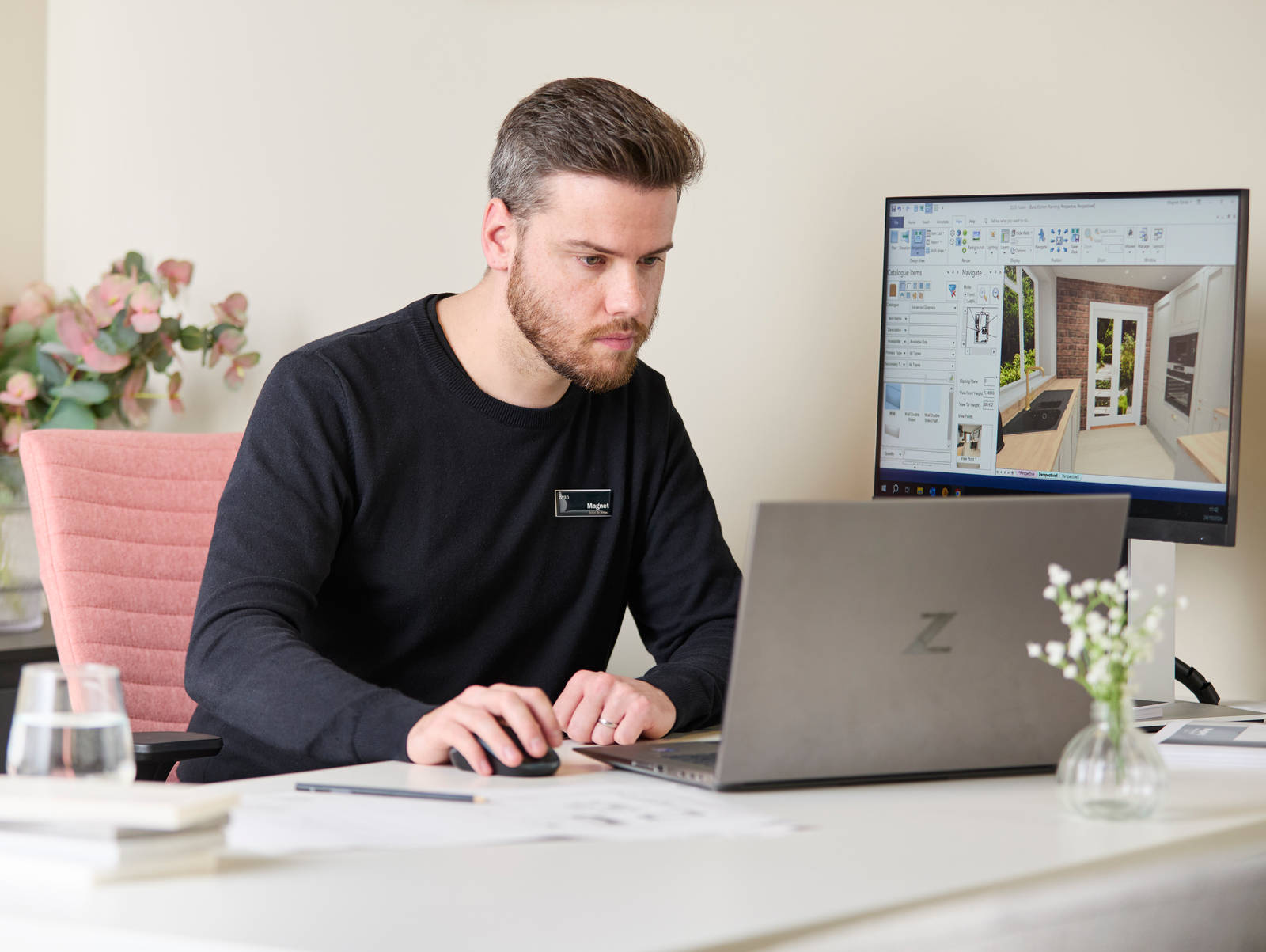 Magnet colleague at a desk at a Magnet store designing a kitchen on a computer