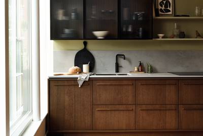 Magnet's kitchen Nordic Nature, with oak cabinetry and display cabinets with fluted glass.