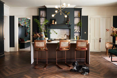 Ludlow, a traditional Shaker-style kitchen range in the shade Arboretum Green, combined with a dark wood panel kitchen island