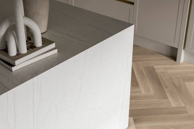 Close-up of Kitchen island with marble worktop and decorative side panel.