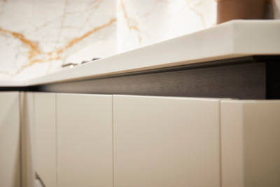 Integra Soho Limestone and Nutmeg is a frameless slab door with integrated handles in a smooth paint finish.
