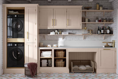 Utility room Wardley Shell cabinetry with washing machine and dryer built-in, a countertop and wall cabinets all matching, a laundry basket on the floor next to washing machine.