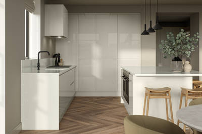 Corner of Luna Gloss Limestone kitchen with tall cabinets, kitchen island featuring an integrated oven, a breakfast bar with wood stools, a black tap and white extractor hood, Amtico smouldered oak in parquet flooring.