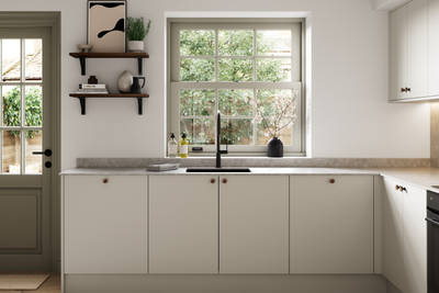 Modern slab kitchen Ascoli in neutral shade Limestone with brass knobs and black tap