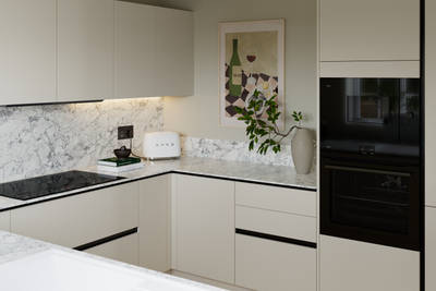 Light neutral shade fluted kitchen  with integrated appliances, white and grey marble worktop and upstand.