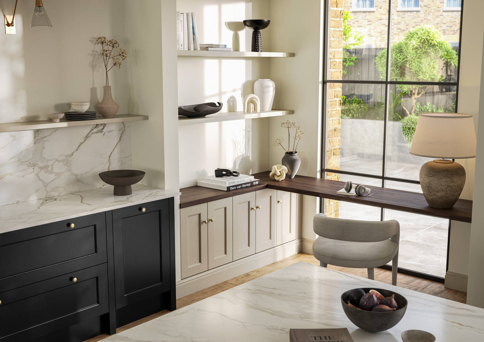 View over kitchen island in Traditional Shaker-style tactile woodgrain Ludlow Sumi Black kitchen, brass details, and dark wood worktop in home office with Ludlow French clay seating area by black metal frame full height window.