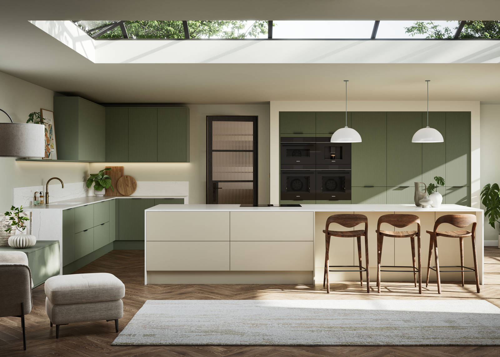 Green fluted kitchen fronts on tall cabinets with built-in appliances and black handles, light neutral shade kitchen island with white worktop and wooden barstools.